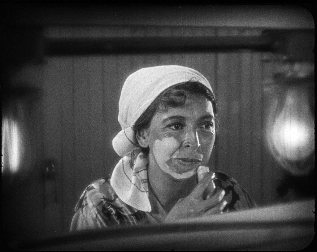 Gale Henry applying makeup to her face in the 1927 film STRANDED